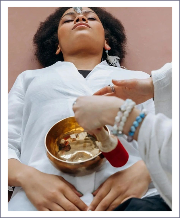 A woman is being given a bowl of water