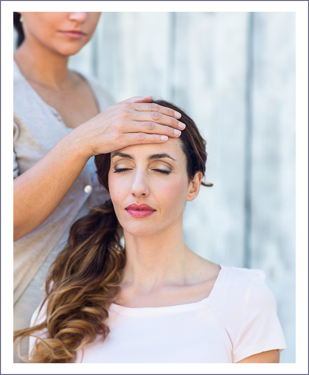 A woman is getting her hair combed by another person.