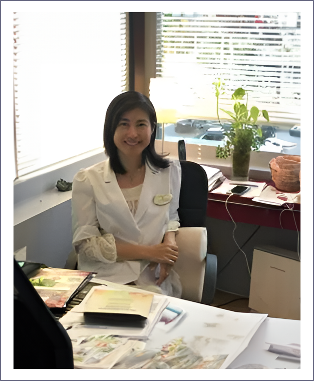 A woman sitting at her desk in front of papers.