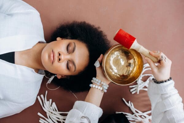 A woman laying on the ground with her eyes closed.